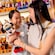 A mother and her young daughter, embracing and holding a Minnie Mouse plush toy in a toy shop